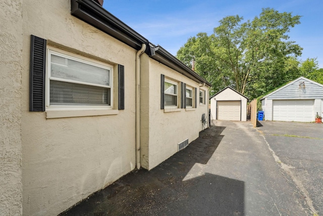 1317 Broadview Ave, Columbus, OH 43212 - view of home's exterior featuring stucco siding, a detached garage, and an outbuilding