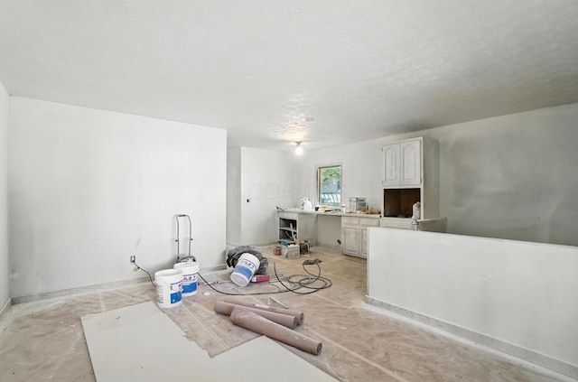 31 S Wheatland Ave, Columbus, OH 43204 - living area with a textured ceiling and concrete flooring