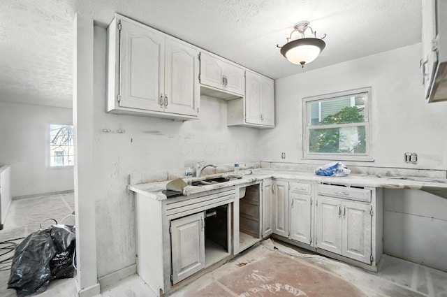 31 S Wheatland Ave, Columbus, OH 43204 - kitchen with a textured ceiling and white cabinetry