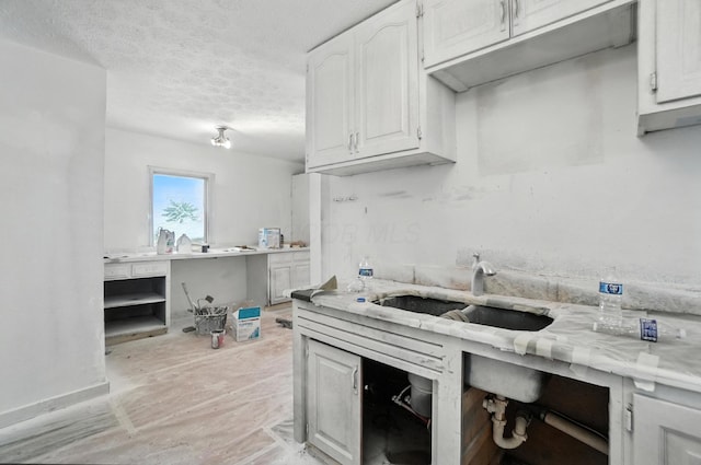 31 S Wheatland Ave, Columbus, OH 43204 - kitchen featuring light countertops, white cabinetry, and a textured ceiling