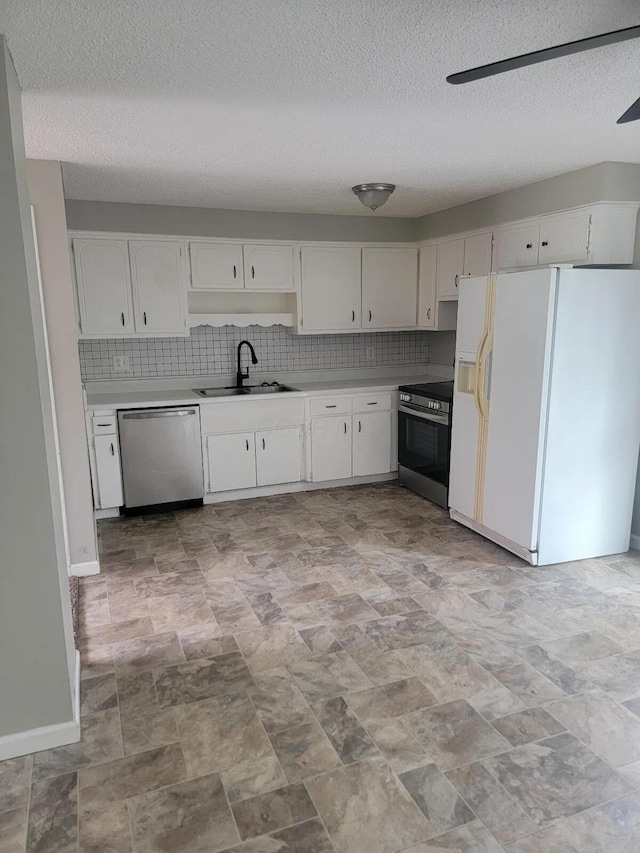 4867 Foxcroft Ct, Columbus, OH 43232 - kitchen with stainless steel appliances, white cabinetry, light countertops, a textured ceiling, and tasteful backsplash