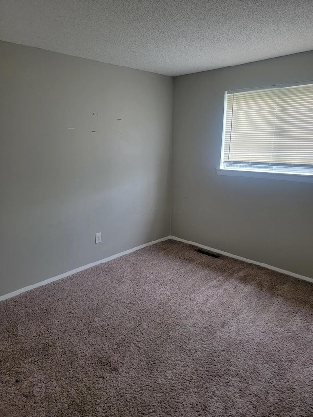 4867 Foxcroft Ct, Columbus, OH 43232 - empty room with carpet floors and a textured ceiling
