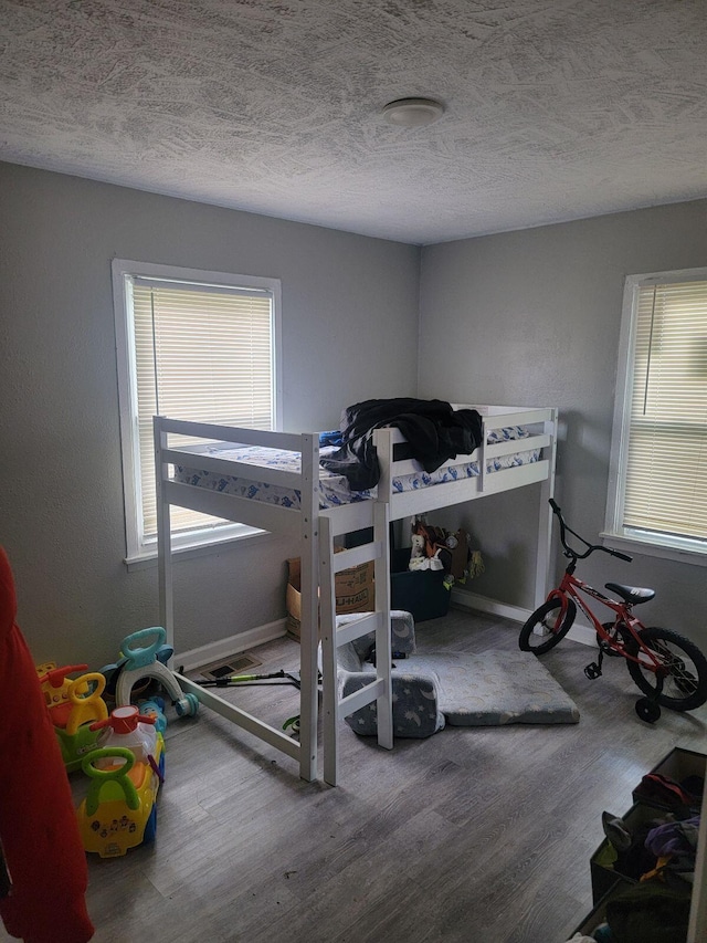 1922 Gault St, Columbus, OH 43205 - bedroom with wood finished floors and a textured ceiling