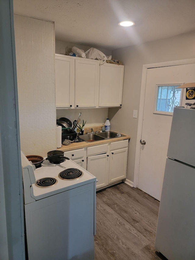 1922 Gault St, Columbus, OH 43205 - kitchen featuring white appliances, wood finished floors, white cabinets, and light countertops