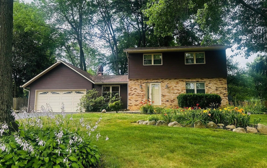 10 Aster Ct SW, Etna, OH 43062 - colonial house featuring brick siding, an attached garage, and a front lawn