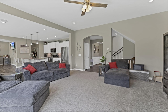 7250 Konold Ct, Canal Winchester, OH 43110 - living room featuring ceiling fan, dark colored carpet, arched walkways, recessed lighting, and stairs