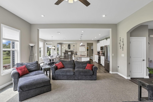 7250 Konold Ct, Canal Winchester, OH 43110 - living area featuring dark colored carpet, a ceiling fan, arched walkways, and recessed lighting