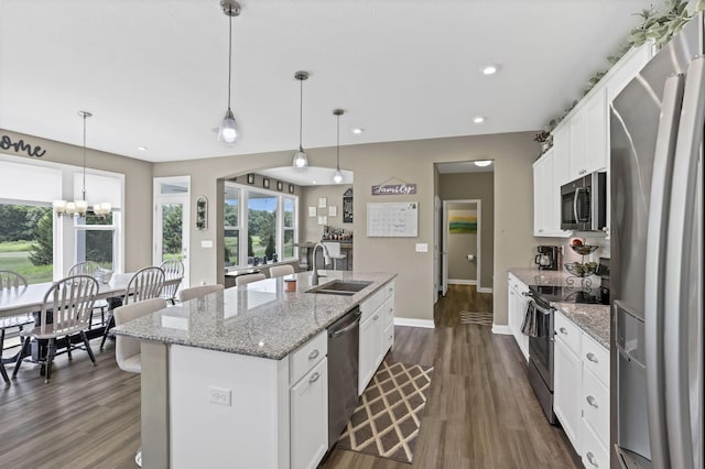 7250 Konold Ct, Canal Winchester, OH 43110 - kitchen featuring appliances with stainless steel finishes, a kitchen island with sink, dark wood finished floors, white cabinets, and recessed lighting