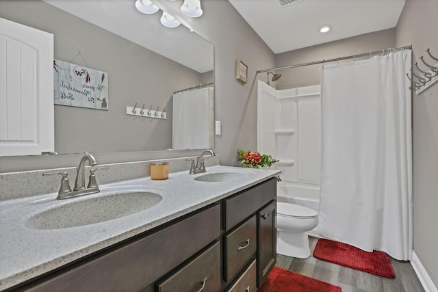 7250 Konold Ct, Canal Winchester, OH 43110 - bathroom featuring double vanity, wood finished floors, and shower / tub combo