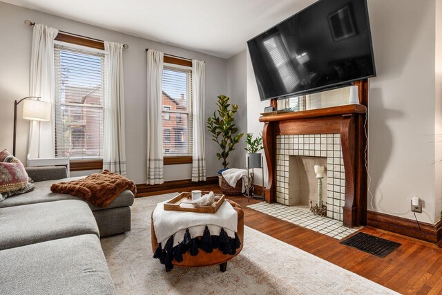 482 E Whittier St, Columbus, OH 43206 - living area featuring wood finished floors and a tiled fireplace