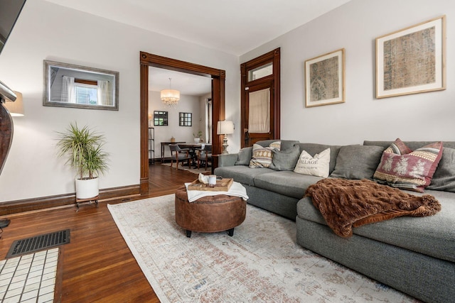 482 E Whittier St, Columbus, OH 43206 - living room featuring wood finished floors and a chandelier