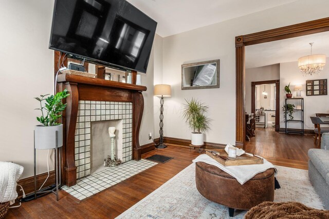 482 E Whittier St, Columbus, OH 43206 - living room featuring wood finished floors and a chandelier