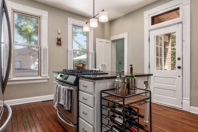 482 E Whittier St, Columbus, OH 43206 - kitchen with stainless steel range with gas stovetop, dark wood finished floors, and hanging light fixtures