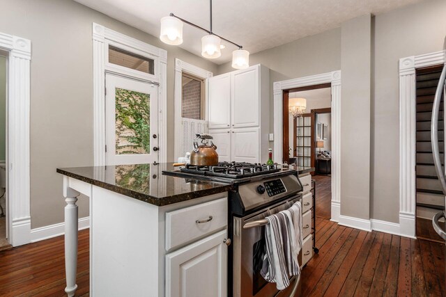 482 E Whittier St, Columbus, OH 43206 - kitchen featuring stainless steel gas range, dark wood finished floors, white cabinetry, a chandelier, and dark stone countertops