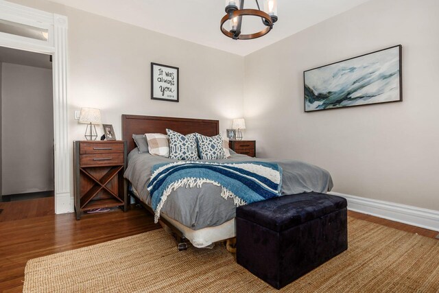 482 E Whittier St, Columbus, OH 43206 - bedroom featuring wood finished floors and a chandelier