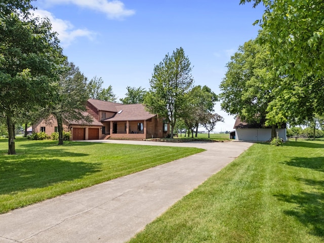 1178 London Rd, West Jefferson, OH 43162 - view of front of home with a front lawn, concrete driveway, brick siding, and an attached garage