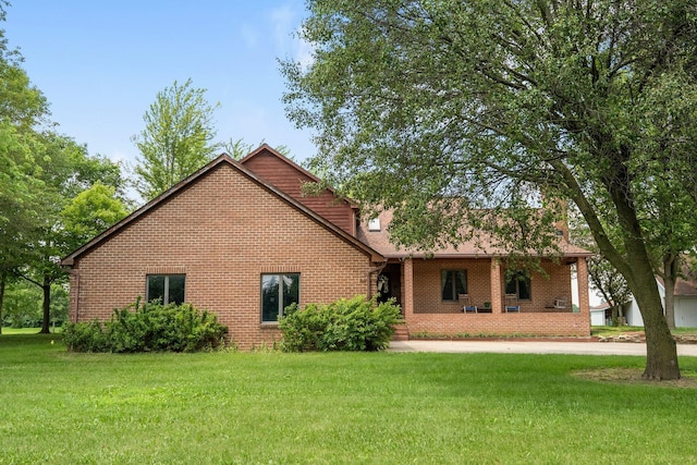 1178 London Rd, West Jefferson, OH 43162 - view of front of home with brick siding, a front yard, and covered porch