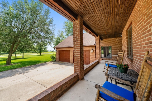 1178 London Rd, West Jefferson, OH 43162 - view of patio featuring driveway and a garage