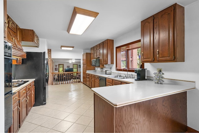 1178 London Rd, West Jefferson, OH 43162 - kitchen with black appliances, light tile patterned floors, light countertops, a peninsula, and brown cabinets