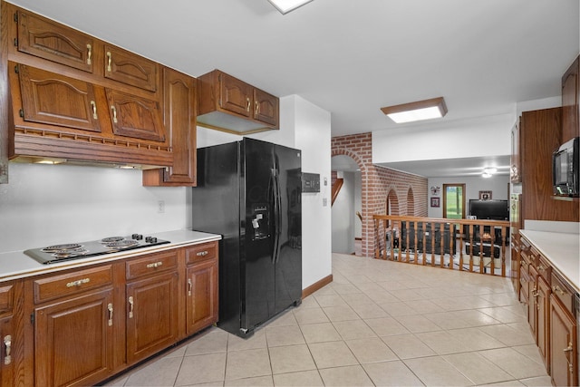 1178 London Rd, West Jefferson, OH 43162 - kitchen featuring black appliances, light countertops, brown cabinetry, and light tile patterned flooring
