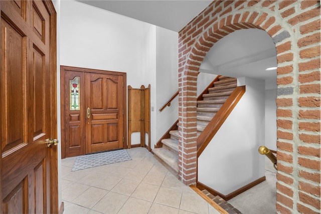 1178 London Rd, West Jefferson, OH 43162 - foyer entrance featuring light tile patterned floors, stairs, and arched walkways