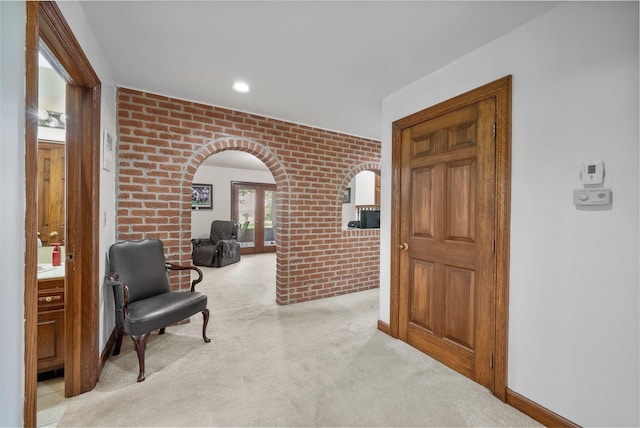1178 London Rd, West Jefferson, OH 43162 - sitting room featuring brick wall, arched walkways, and light colored carpet