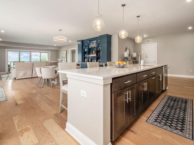 5285 Highpointe Lakes Dr Unit 201, Westerville, OH 43081 - kitchen featuring wine cooler, an island with sink, light wood-style floors, recessed lighting, and pendant lighting