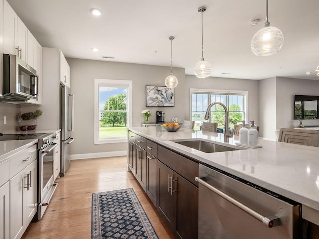 5285 Highpointe Lakes Dr Unit 201, Westerville, OH 43081 - kitchen with stainless steel appliances, plenty of natural light, light stone counters, light wood-type flooring, and recessed lighting