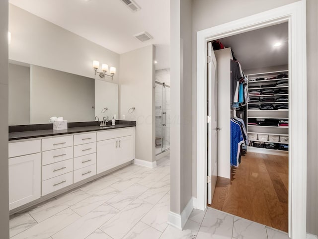 5285 Highpointe Lakes Dr Unit 201, Westerville, OH 43081 - full bathroom featuring marble finish floors, a spacious closet, vanity, and a shower stall