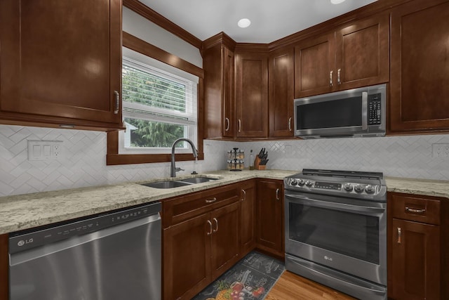 2579 Wickliffe Rd, Columbus, OH 43221 - kitchen featuring appliances with stainless steel finishes, light stone counters, tasteful backsplash, and wood finished floors