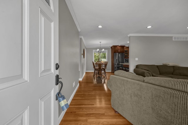 2579 Wickliffe Rd, Columbus, OH 43221 - living area featuring ornamental molding, a chandelier, light wood-style floors, and recessed lighting