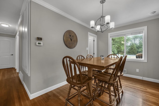 2579 Wickliffe Rd, Columbus, OH 43221 - dining space featuring crown molding, dark wood-type flooring, and a chandelier