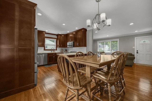 2579 Wickliffe Rd, Columbus, OH 43221 - dining room featuring ornamental molding, plenty of natural light, recessed lighting, wood finished floors, and a chandelier