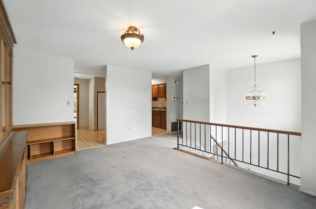 4143 Jonquil St, Columbus, OH 43224 - unfurnished room featuring light carpet and a chandelier