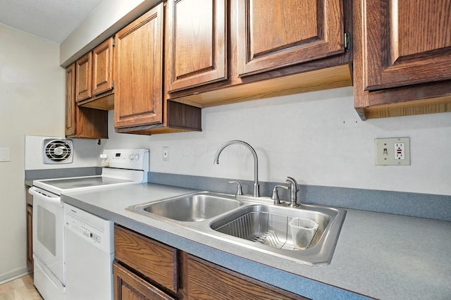 4143 Jonquil St, Columbus, OH 43224 - kitchen featuring white appliances, light countertops, and brown cabinetry