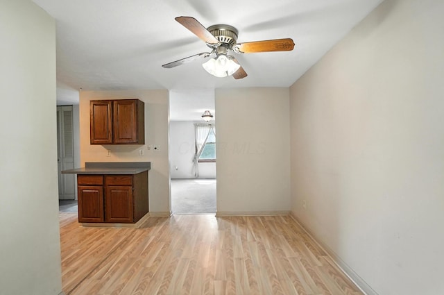 4143 Jonquil St, Columbus, OH 43224 - kitchen with ceiling fan, light wood-style floors, and brown cabinets