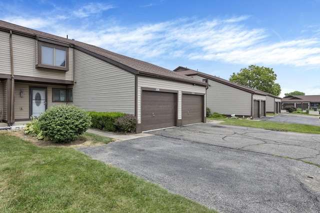 5276 Marci Way, Columbus, OH 43228 - view of home's exterior featuring community garages and roof with shingles