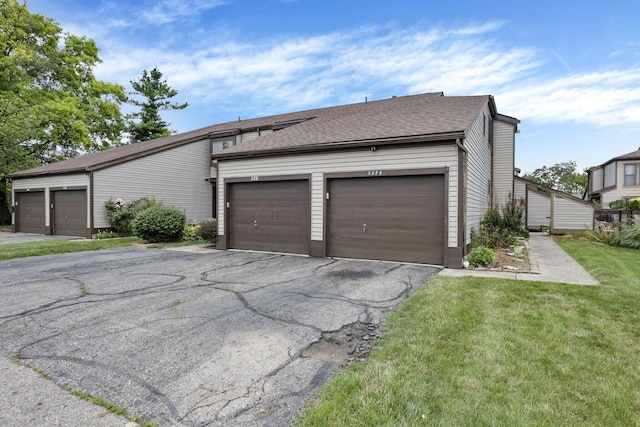 5276 Marci Way, Columbus, OH 43228 - view of side of property featuring community garages, a lawn, and a shingled roof