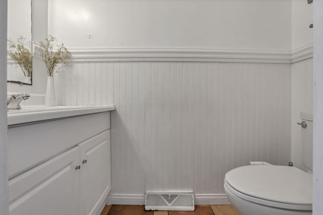 5276 Marci Way, Columbus, OH 43228 - half bathroom with vanity, a wainscoted wall, and wood finished floors