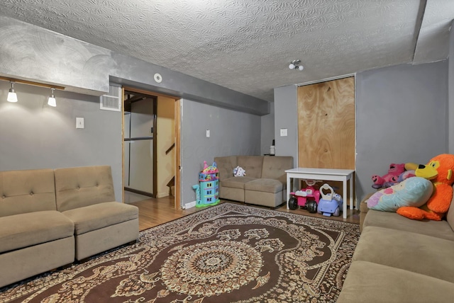 5276 Marci Way, Columbus, OH 43228 - living room featuring wood finished floors, stairway, and a textured ceiling