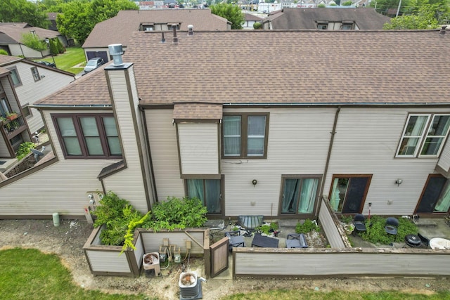 5276 Marci Way, Columbus, OH 43228 - back of property featuring a shingled roof and a garden