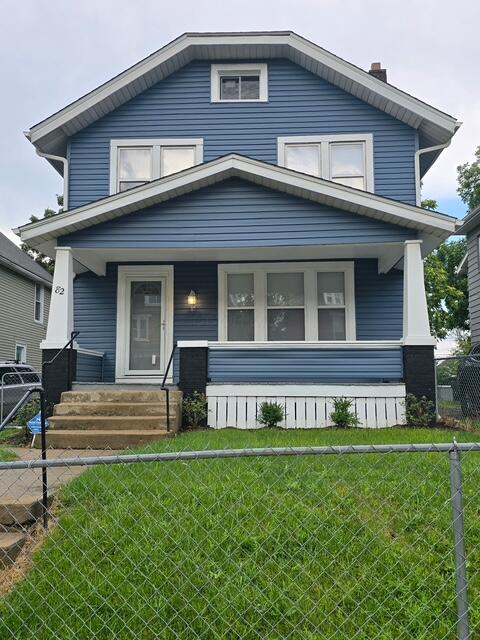82 Whitethorne Ave, Columbus, OH 43223 - traditional style home with covered porch, a fenced front yard, and a chimney