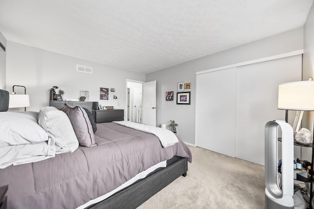 8194 Baltimore Ave Unit 6E, Westerville, OH 43081 - bedroom with light carpet, a closet, and a textured ceiling