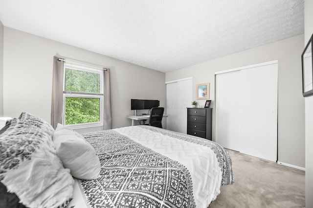 8194 Baltimore Ave Unit 6E, Westerville, OH 43081 - bedroom featuring two closets, carpet, and a textured ceiling