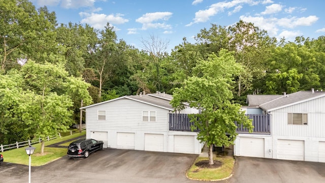711 Cherry Hollow Rd Unit A, Columbus, OH 43228 - view of side of home featuring an attached garage, driveway, and view of scattered trees
