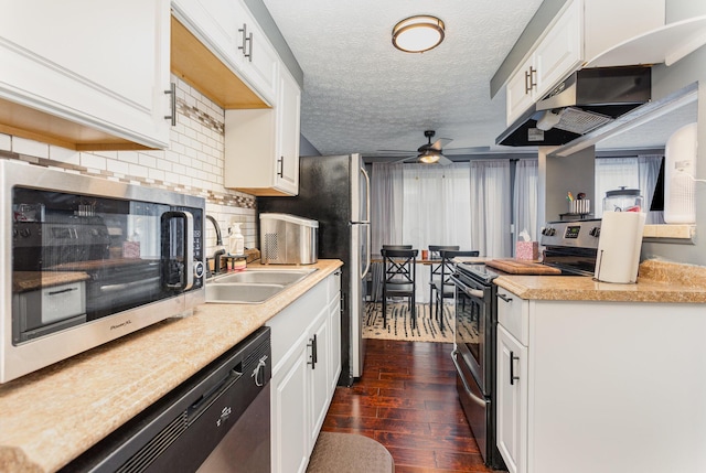 711 Cherry Hollow Rd Unit A, Columbus, OH 43228 - kitchen featuring appliances with stainless steel finishes, under cabinet range hood, a textured ceiling, dark wood-style flooring, and a ceiling fan