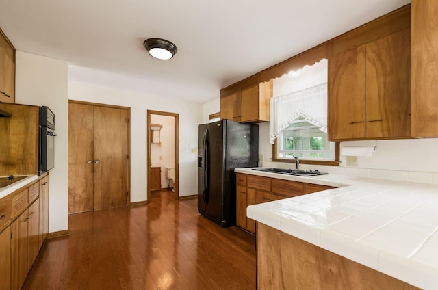 5930 Coonpath Rd NW, Carroll, OH 43112 - kitchen with black appliances, brown cabinetry, and dark wood-type flooring