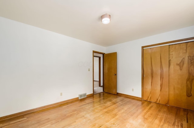5930 Coonpath Rd NW, Carroll, OH 43112 - unfurnished bedroom featuring light wood-style flooring and a closet