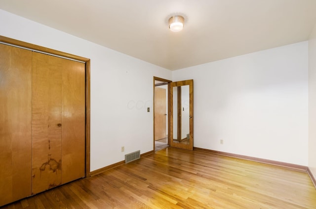 5930 Coonpath Rd NW, Carroll, OH 43112 - unfurnished bedroom featuring light wood-type flooring and a closet