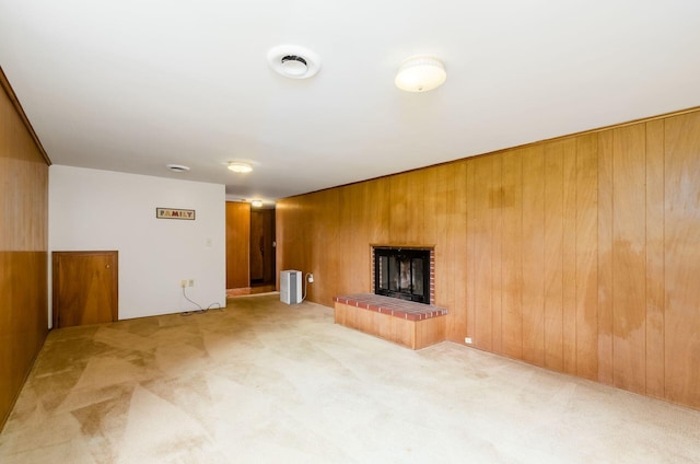 5930 Coonpath Rd NW, Carroll, OH 43112 - unfurnished living room with carpet floors, a brick fireplace, and wood walls